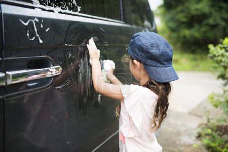 Téléchargez les photos : Petite fille lavant une voiture - en image libre de droit