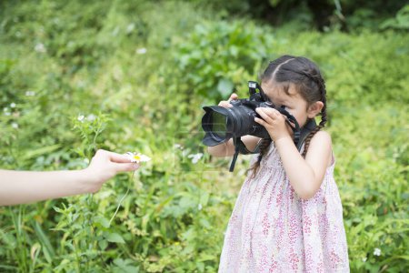 Photo for Little girl to take a picture on camera - Royalty Free Image