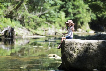 Photo for Happy little girl playing in Mountain stream - Royalty Free Image