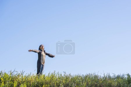 A beautiful Japanese woman standing in the meadow
