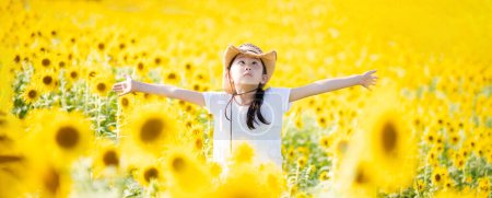 Photo for Girl playing in a sunflower field - Royalty Free Image