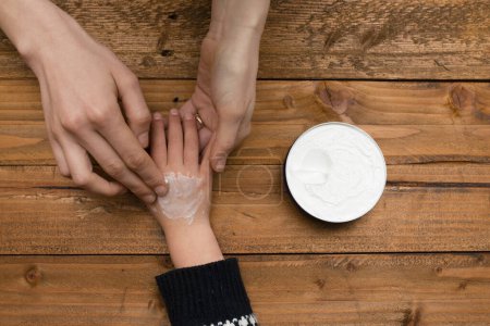 Photo for Child's hand to treat mother's wound - Royalty Free Image