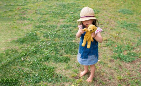 Photo for Little girl playing with teddy bear - Royalty Free Image