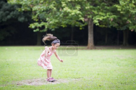 Photo for Girl running on the lawn in park - Royalty Free Image