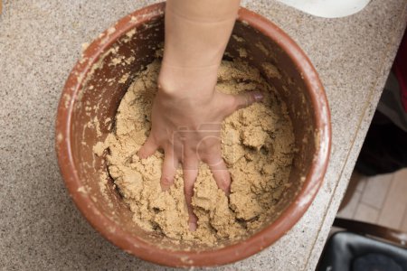 Photo for Woman's hand making rice bran pickles - Royalty Free Image