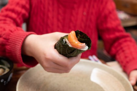 A child who makes hand rolled sushi