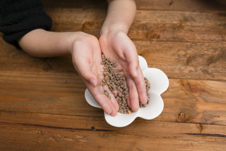 Child's hands with lentils
