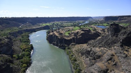 River in the gorge. Calm mountain river. River in a volcanic gorge. Nature of America. Nature of Idaho. Town of Twin Falls. Volcanic rocks. Rocky banks of the river. North America nature. Nature landscape. Landscape of mountain river. Canyon.