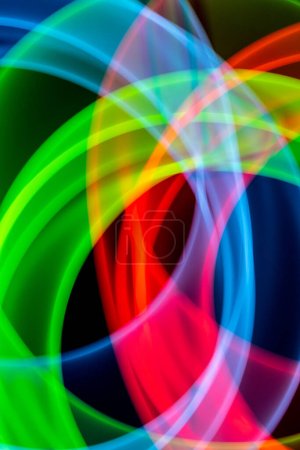Photo for A Neon Wavy Light Nightclub Background Swirls on Black Background - Royalty Free Image