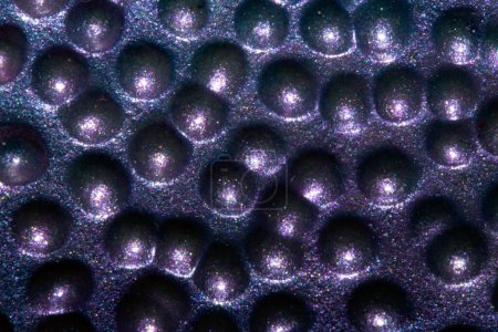 A Alien trypophobia holes in a shiny sci-fi close up background