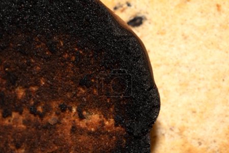 A Very Burnt Bread Roll Toast and a Lightly Toasted Close Up Texture Close Up