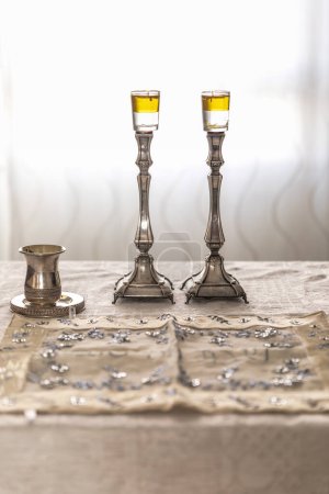Photo for Shabbat image - silver candlesticks Lightened with olive oil, and silver Kiddush cup - Royalty Free Image