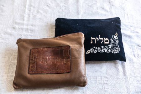 Photo for Two Tallit bags, saying "talit" in Hebrew on it, placed on a table. white background . Jewish symbols - Royalty Free Image