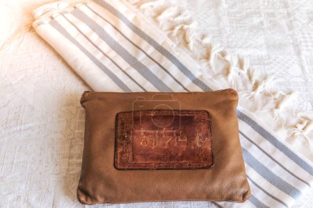 Photo for A brown Tallit bag written on it "Tallit" in Hebrew, and a blue and white Tallit on a white background. jewish symbols. - Royalty Free Image