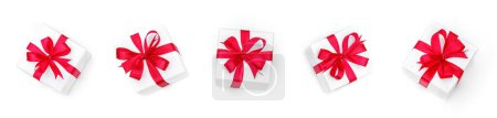 Foto de Cajas de regalo para Feliz Navidad y vacaciones con lazos rojos aislados sobre fondo blanco. Feliz Año Nuevo y Navidad, vista superior - Imagen libre de derechos