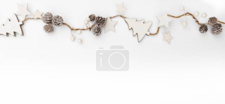 Photo for Merry Christmas garland made of white cones, berries, stars on white background. Happy New Year and Xmas, top view - Royalty Free Image