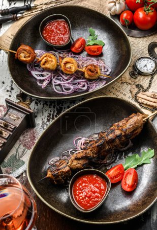 Photo for Grilled meat shish on skewers with vegetables and tomato sauce on the plate. Healthy food. Hot meat dishes, kebab food, closeup, selective focus - Royalty Free Image