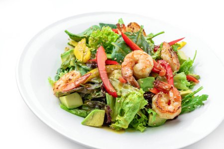 Photo for Healthy fresh salad with shrimp or prawns, avocado, lettuce, spinach, sesame, bell pepper and sauce in plate isolated on white background. Healthy food, top view - Royalty Free Image