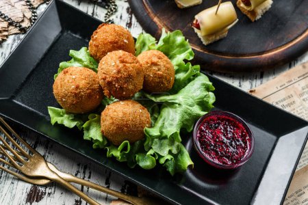 Photo for Deep fried cheese balls breaded and deep fried with berries sauce on rustic background. Appetizer snack, close up - Royalty Free Image