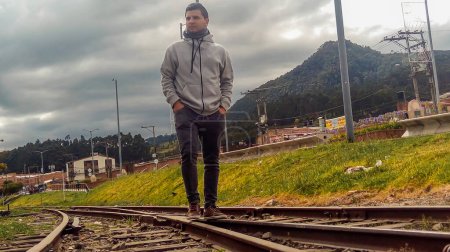 Serious Hispanic man on train rail in Zipaquira - Cundinamarca - Colombia