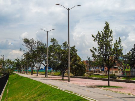 View of a path with several light poles in the day in a Bosa park in Bogota - Colombia