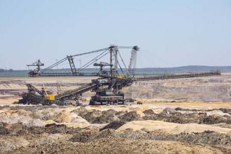Photo for Lausitz, Germany - June 24, 2022: A massive excavator in a huge opencast coal mine in Germany - Royalty Free Image