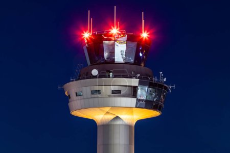 Salzburg, Austria - January 27, 2024: Air traffic control tower at Salzburg airport tower at night with futuristic lights and architecture
