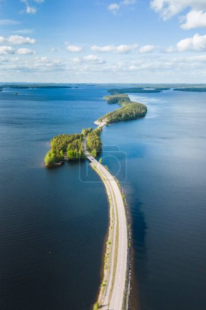 Aerial view of Pulkkilanharju Ridge, Paijanne National Park, southern part of Lake Paijanne. Blue lakes and a winding road from above