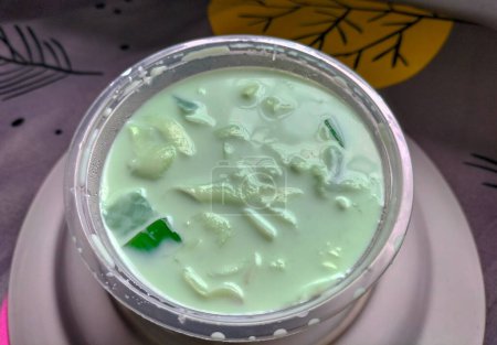 Selective focus. Buko Pandan is a dessert originated from the Philippines. Made of jelly, young coconut and whip cream. Best served cold.
