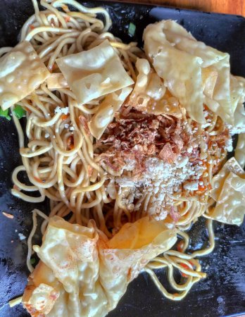 Gacoan Noodles or "Mie Gacoan"  is one of the popular foods in Indonesia. Made from noodles served with spicy spices and fried dumplings. 
