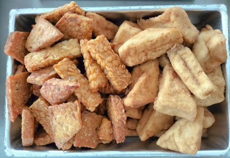 Fried Tempeh and Tofu. One of composition Gudangan. Javanese traditional menu. Vegetable protein.