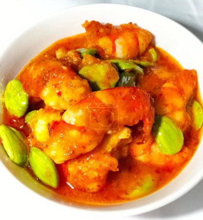 Photo for Petai or Pete with Shrimp, cooked with mashed red chili. This food is called Balado Udang Pete, isolated on dinner preparation. Selective focus. - Royalty Free Image