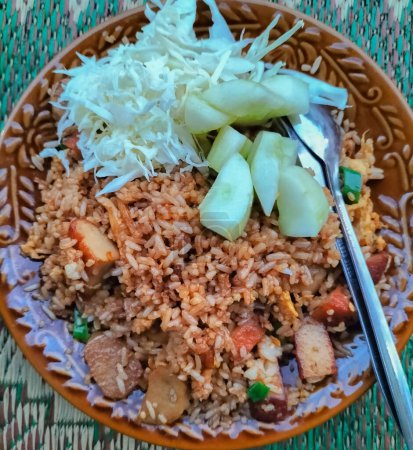 Selective focus. Fried rice is a typical food of Tegal City, Indonesia. This fried rice mixed with chicken slices that have been braised for several hours.