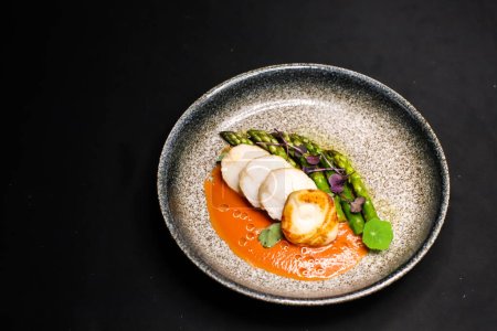 Photo for Fine dining dish with grilled monkfish, asparagus and tomato sauce - Royalty Free Image