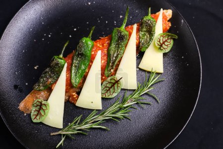 Traditional Spanish appetizer- Pan con Tomate with Manchego cheese and Pimientos de Padron peppers