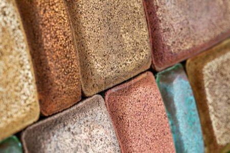Photo for Bricks. Paving tiles. Colored stones. Texture of paving tiles. Cement products. Sidewalk in grass. Tile with embedded metal. - Royalty Free Image