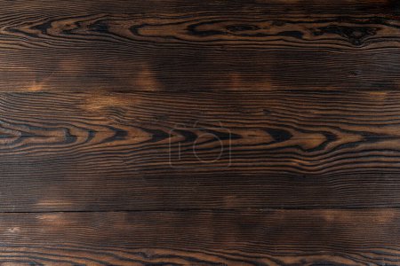 Photo for Beautiful wooden background. Burnt wood background. Wooden surface with a burnt pattern. Tabletop. - Royalty Free Image