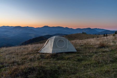 Tourist tent in the mountains. Sunrise in the mountains. Tourist camp and sunrise.
