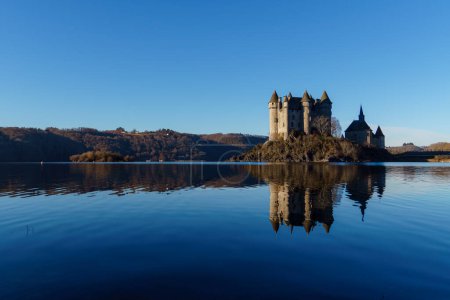 Beautiful castle of Val under a blue sky with a perfect reflexion on the water, France tourism