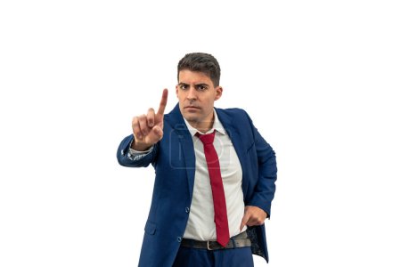 Photo for Displeased expression of a businessman as he looks contrarily at the camera, with a furrowed brow, shaking his head and raising a finger in denial, expressing frustration and anger white background - Royalty Free Image