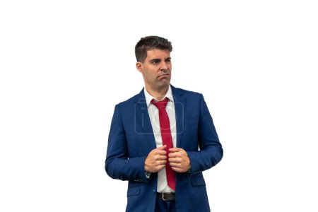 Photo for Perplexed expression of a businessman as he looks to the side while holding his suit, displaying confusion and uncertainty. Dressed in corporate attire, his puzzled expression reflects surprise white background - Royalty Free Image