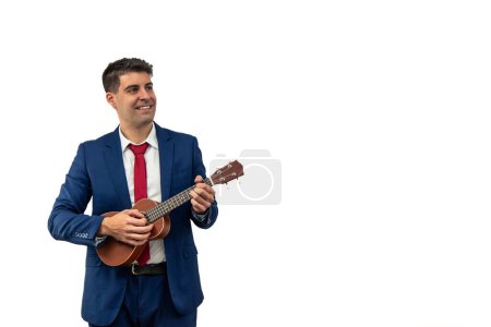 copyspace relaxed executive enjoys playing the ukulele. In a moment of respite from his busy workday, he finds pleasure in music, reflecting a creative and joyful white background