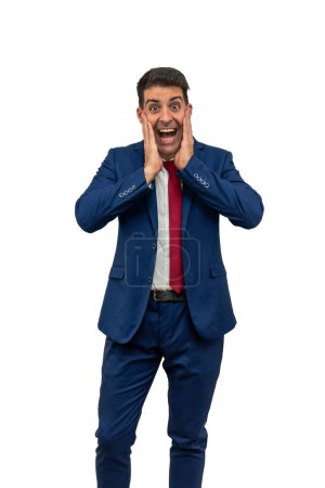 vertical businessman as he holds his hands to his face, expressing joy and surprise. Dressed in a stylish blue suit and tie, his facial expression radiates happiness and excitement white background