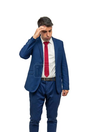 vertical remorseful expression of a businessman as he places his hand on his temple, displaying guilt and regret for his irresponsibility. With a culpable demeanor, white background