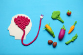 Plasticine figure of man and vegetarian food. Food for mind, charge of energy. Healthy lifestyle, detoxification and antioxidants. Poster #626615632