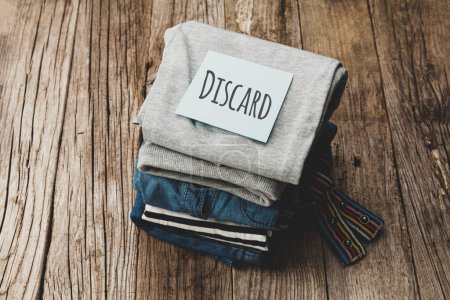 Photo for Stack of old clothes to discard (declutter) or donate. Recycling fabric cotton. - Royalty Free Image