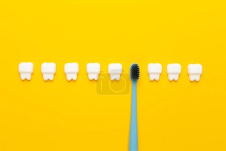 Foto de Dientes blancos sanos con cepillo de dientes sobre fondo amarillo. Higiene oral personal. - Imagen libre de derechos