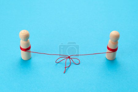 Photo for Love in the distance. Two figures of people connected by a thread, best friends forever. - Royalty Free Image