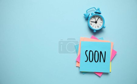 Photo for Blue alarm clock and paper reminder,coming soon. Time management, priorities, efficiency, control and goals. - Royalty Free Image