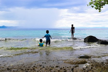 Kinder spielen am Strand